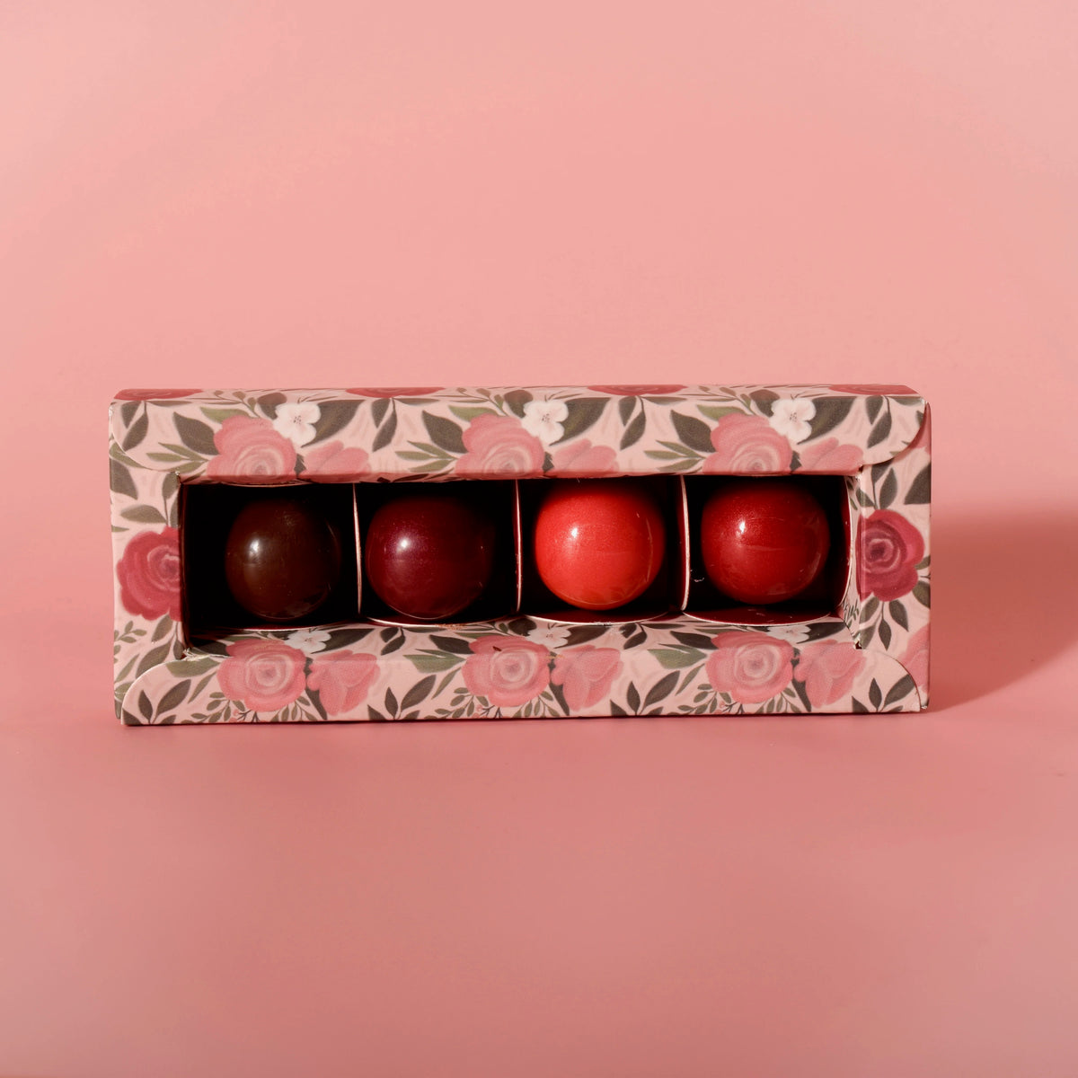 Four artisan chocolate truffles from Garden Square Chocolatier, handmade at Thistles Flower Market, arranged in a gift box