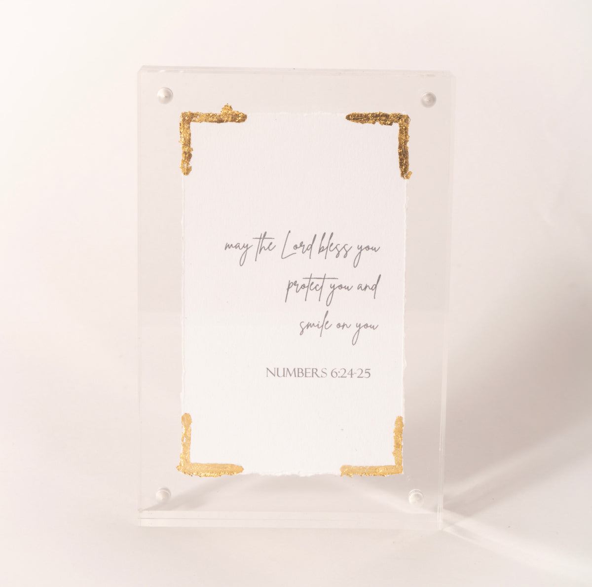 Clear acrylic plaque with gold corners inscribed with the Numbers 6:24-25 blessing, sold at Thistles in Pella, Iowa